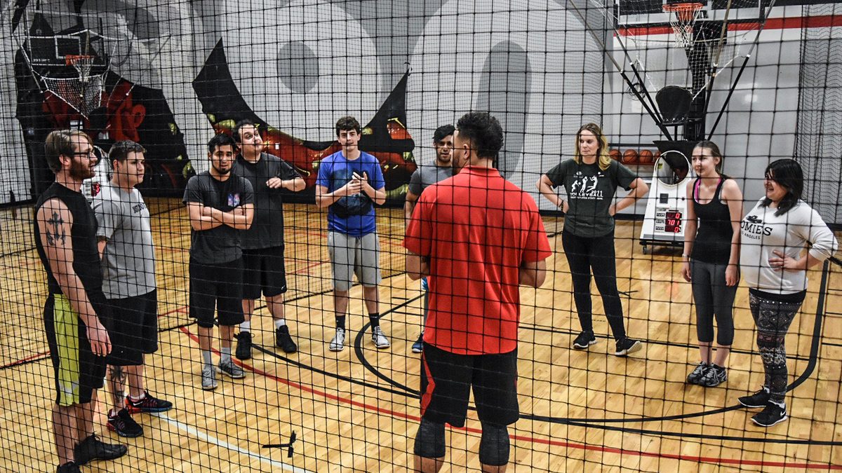 Adults competing on the Shoot 360 skill courts